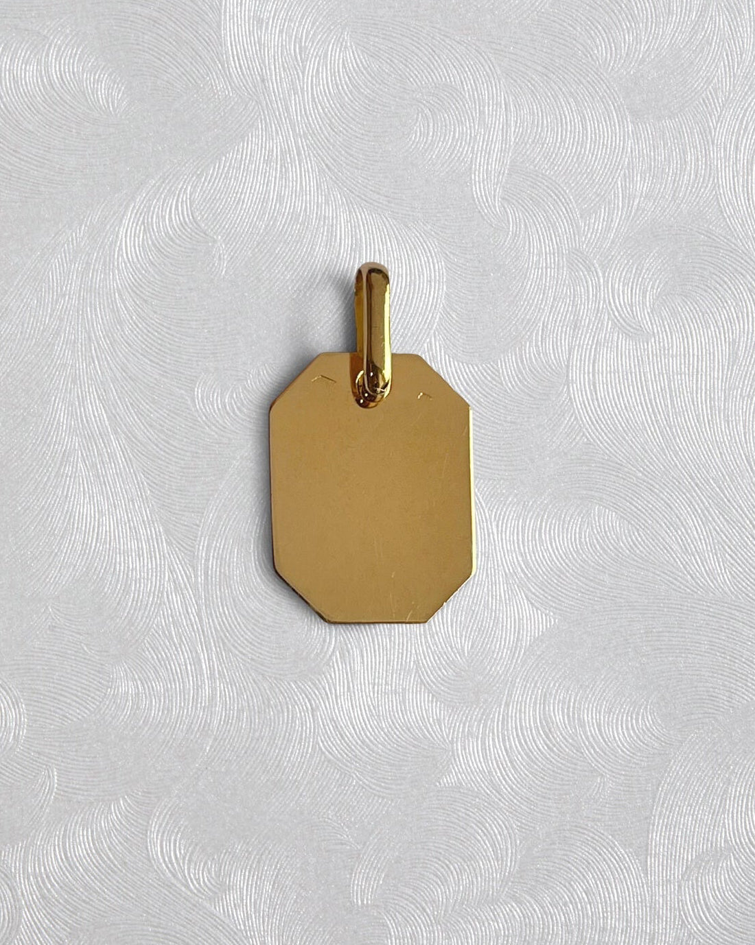 “Reverse of truncated rectangular St. Christopher pendant in 18kt yellow gold showing hallmark and maker’s mark on reverse – Auric Vintage”