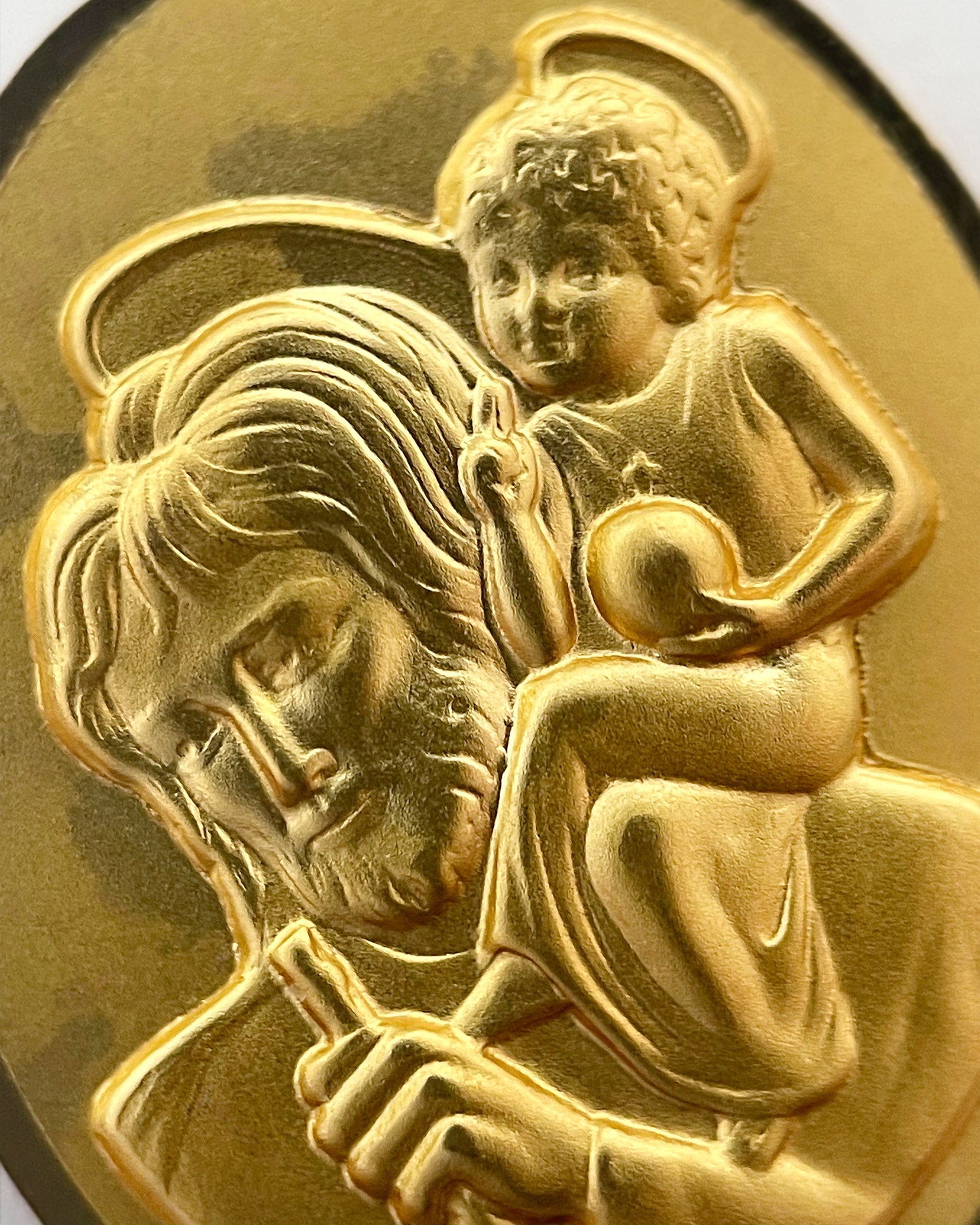 Close-up of 1950s French 18kt gold St. Christopher medal showing saint and Christ Child detail – Auric Vintage