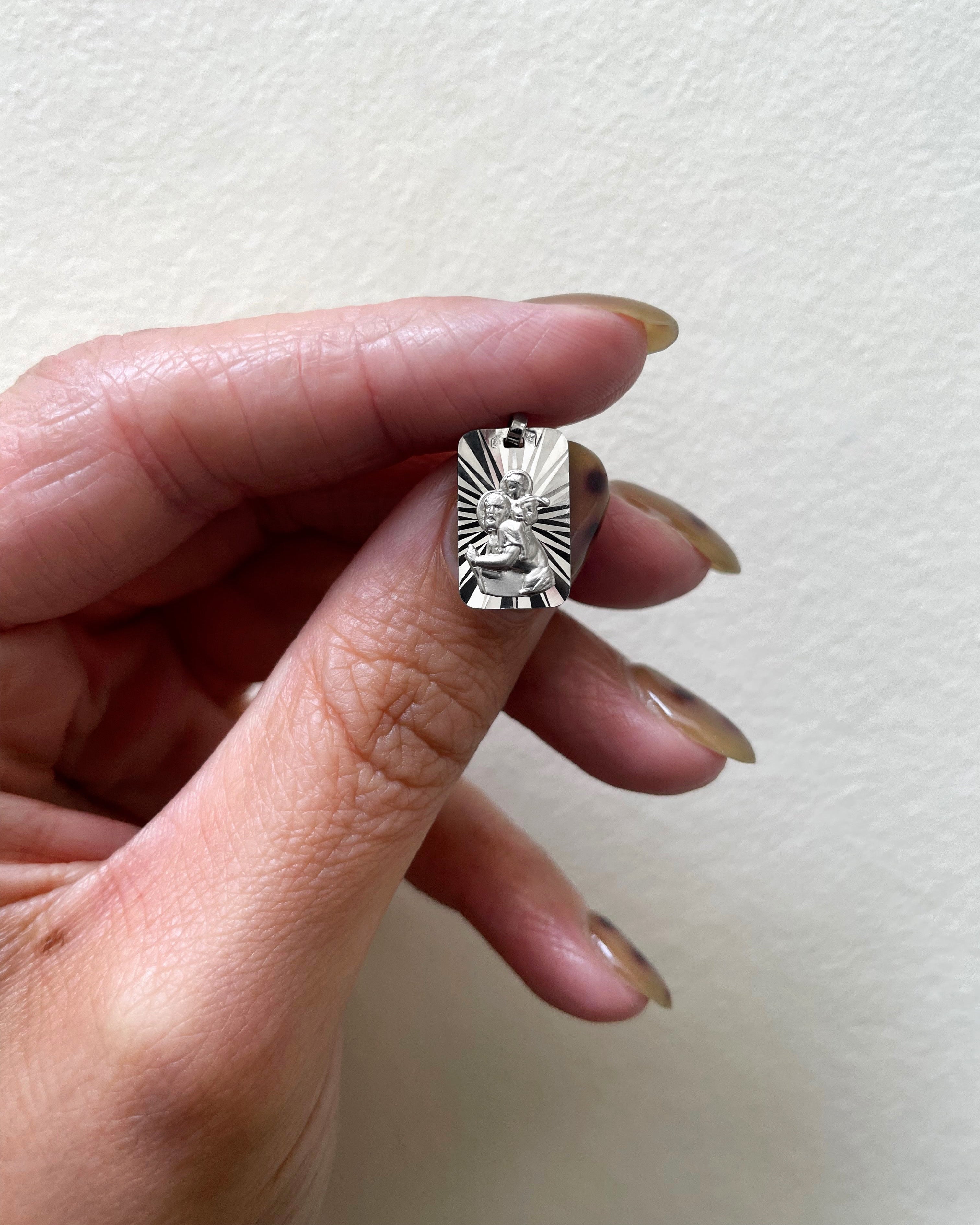 1990s French St. Christopher pendant in 18kt white gold held in hand showing scale and detail – Auric Vintage