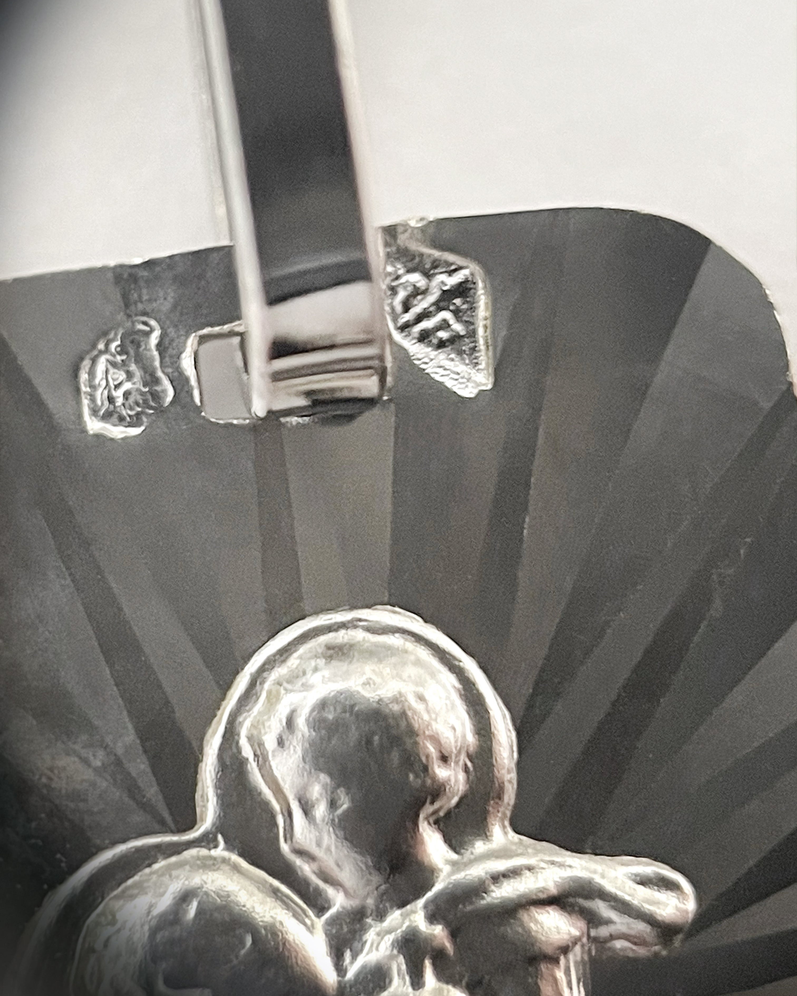 Close-up of 1990s French 18kt white gold St. Christopher pendant showing eagle’s head hallmark and maker’s mark – Auric Vintage