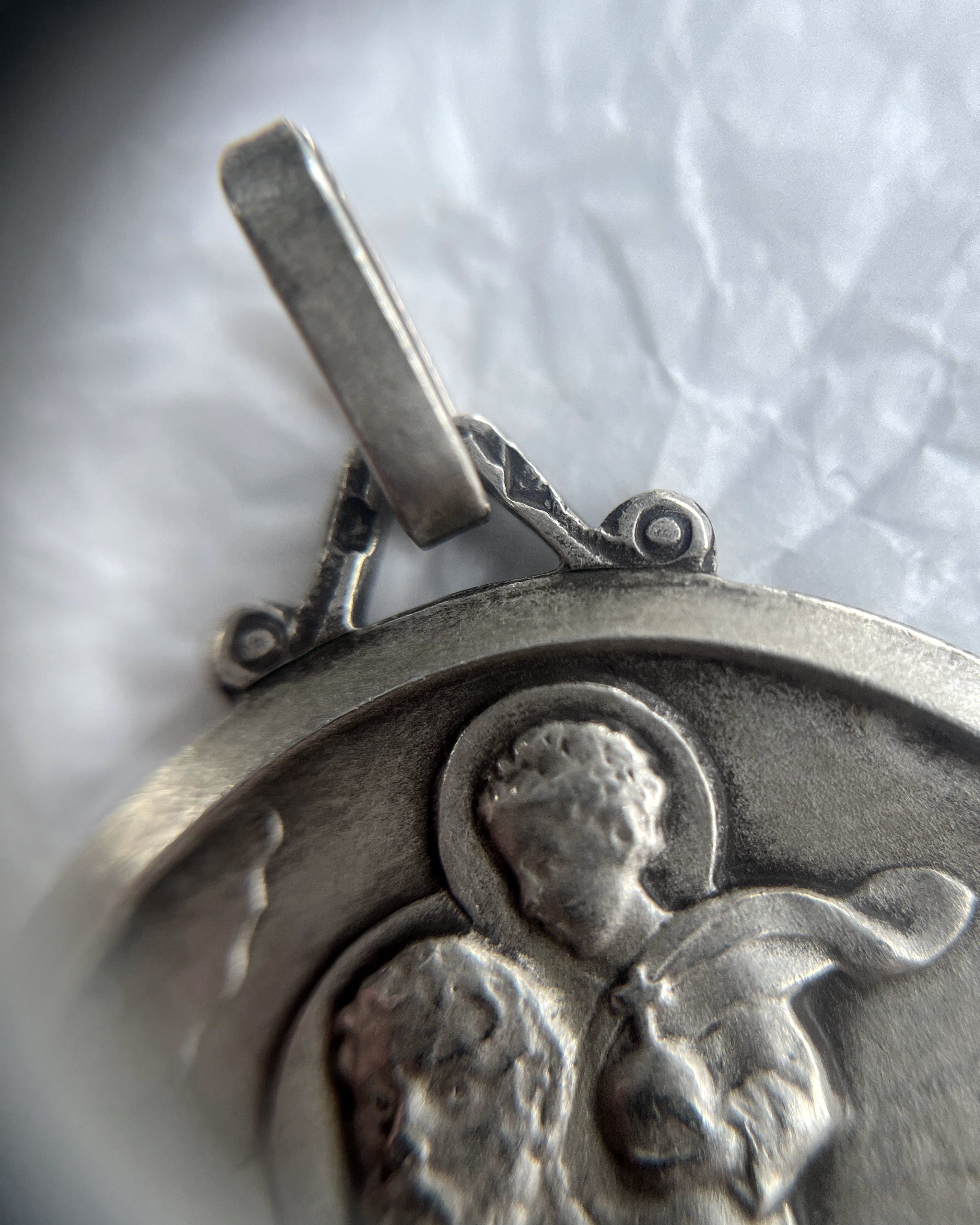 Close-up of 1960s French silver St. Christopher pendant showing hallmark and maker’s mark – Auric Vintage