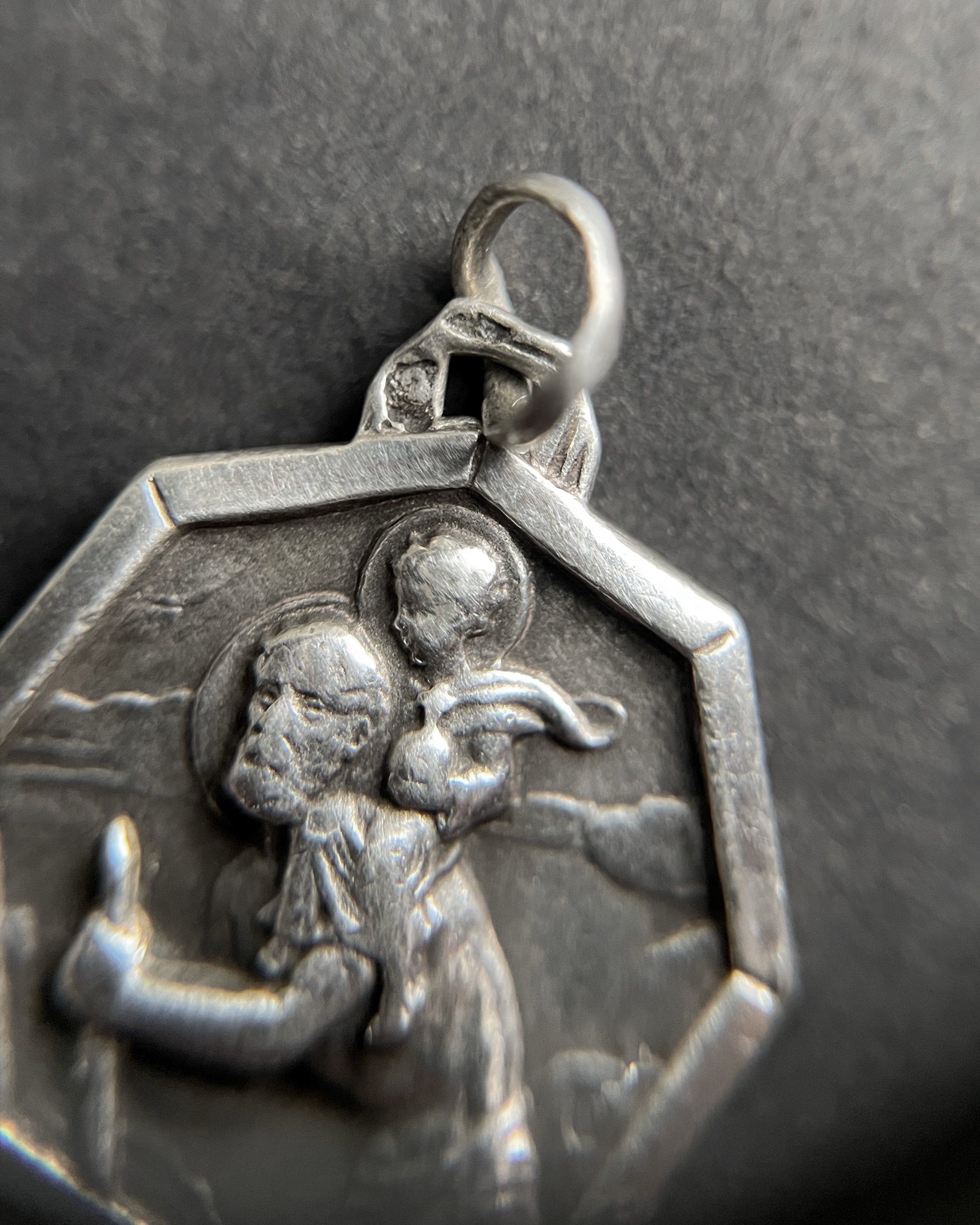 Close-up of 1960s 800 silver St. Christopher pendant showing figure detail – Auric Vintage