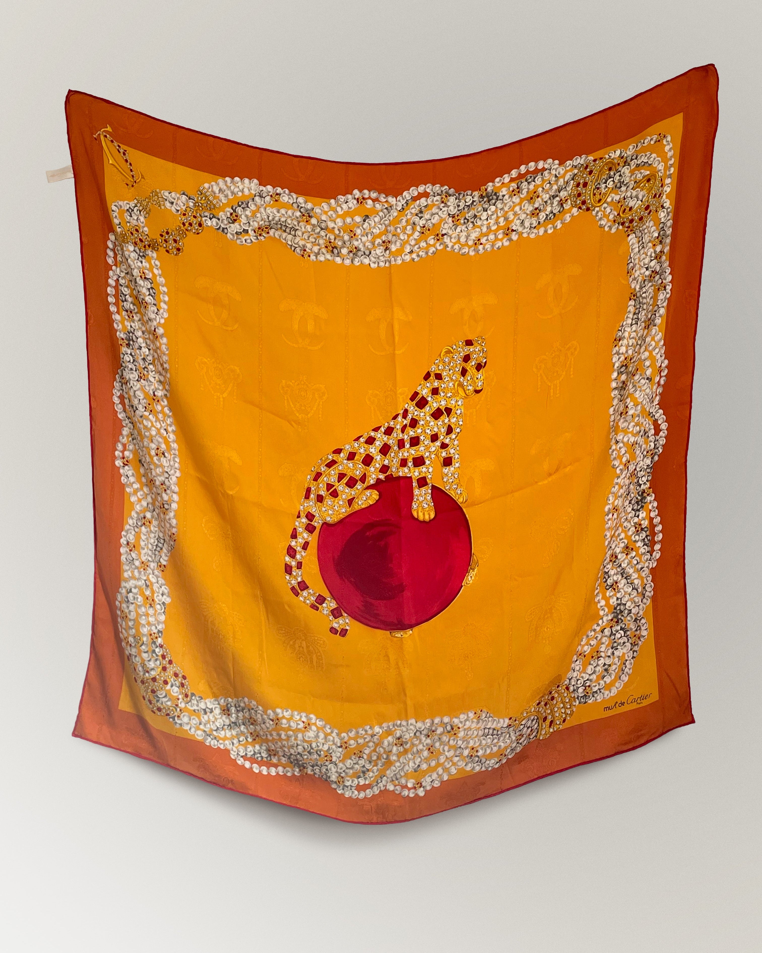 Vintage Must de Cartier silk scarf with panther motif and jewel-toned design on golden-orange ground – Auric Vintage
