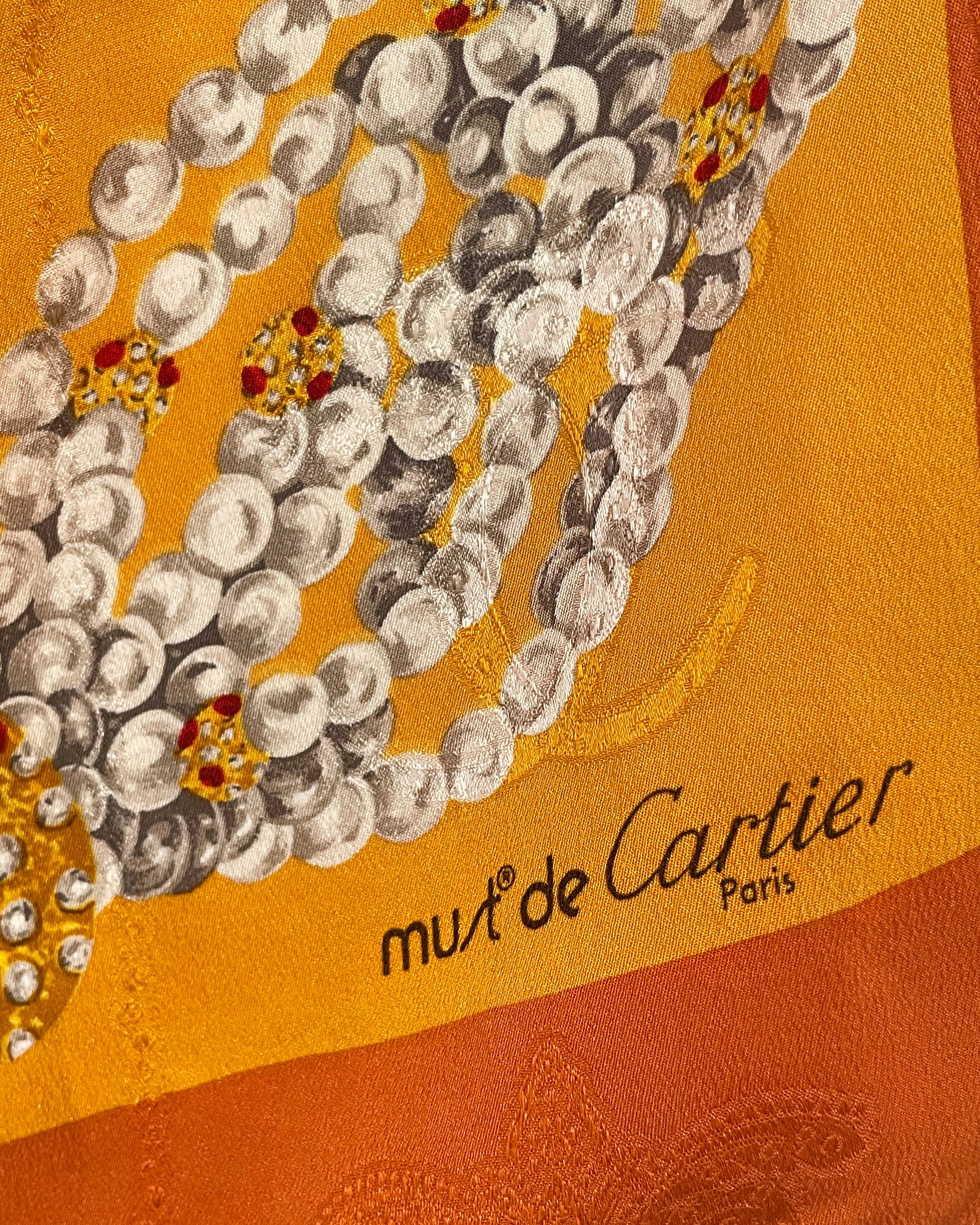 Close-up of vintage Must de Cartier silk scarf showing Must de Cartier logo detail – Auric Vintage