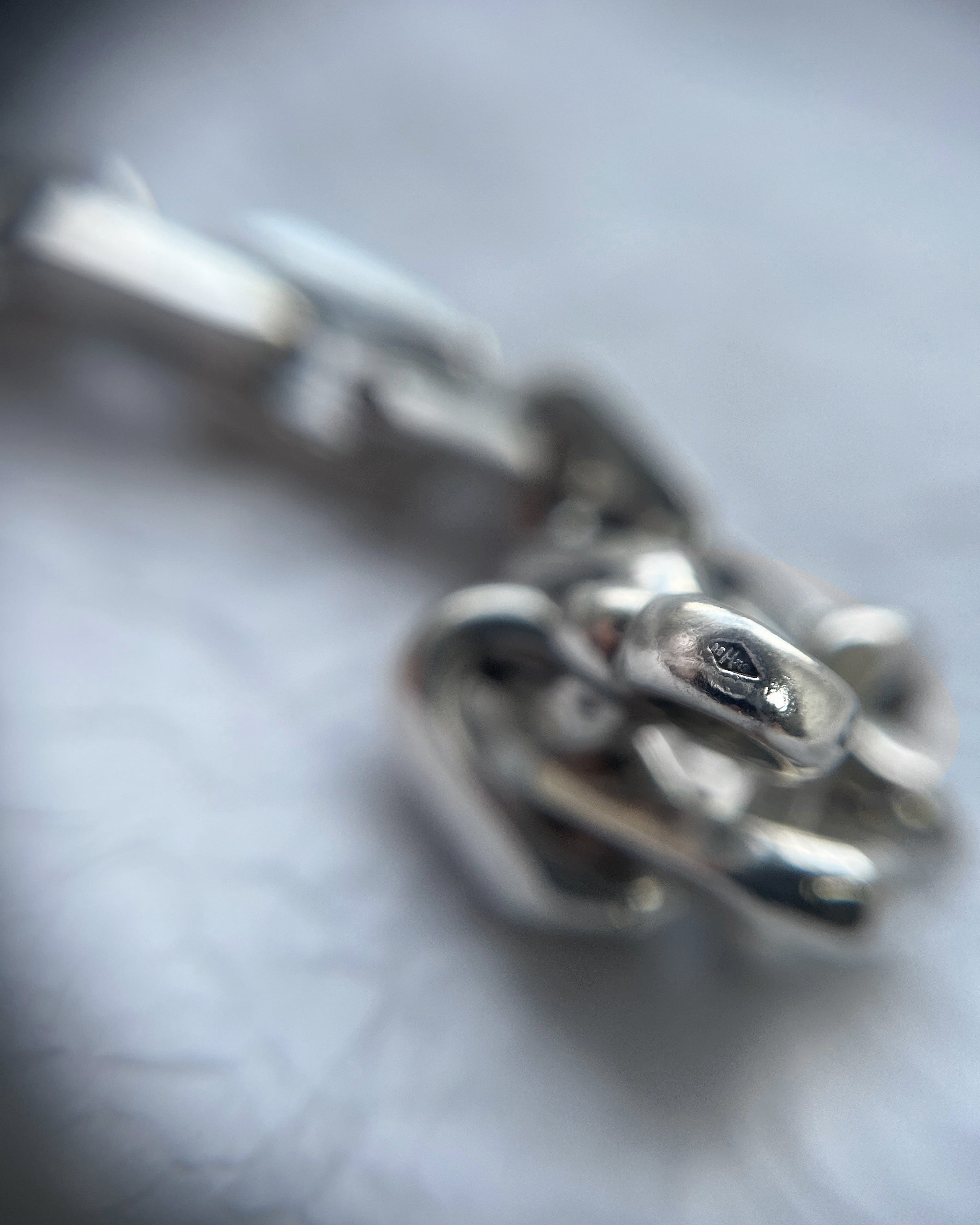 Close-up of vintage French sterling silver belcher bracelet showing maker’s mark – Auric Vintage