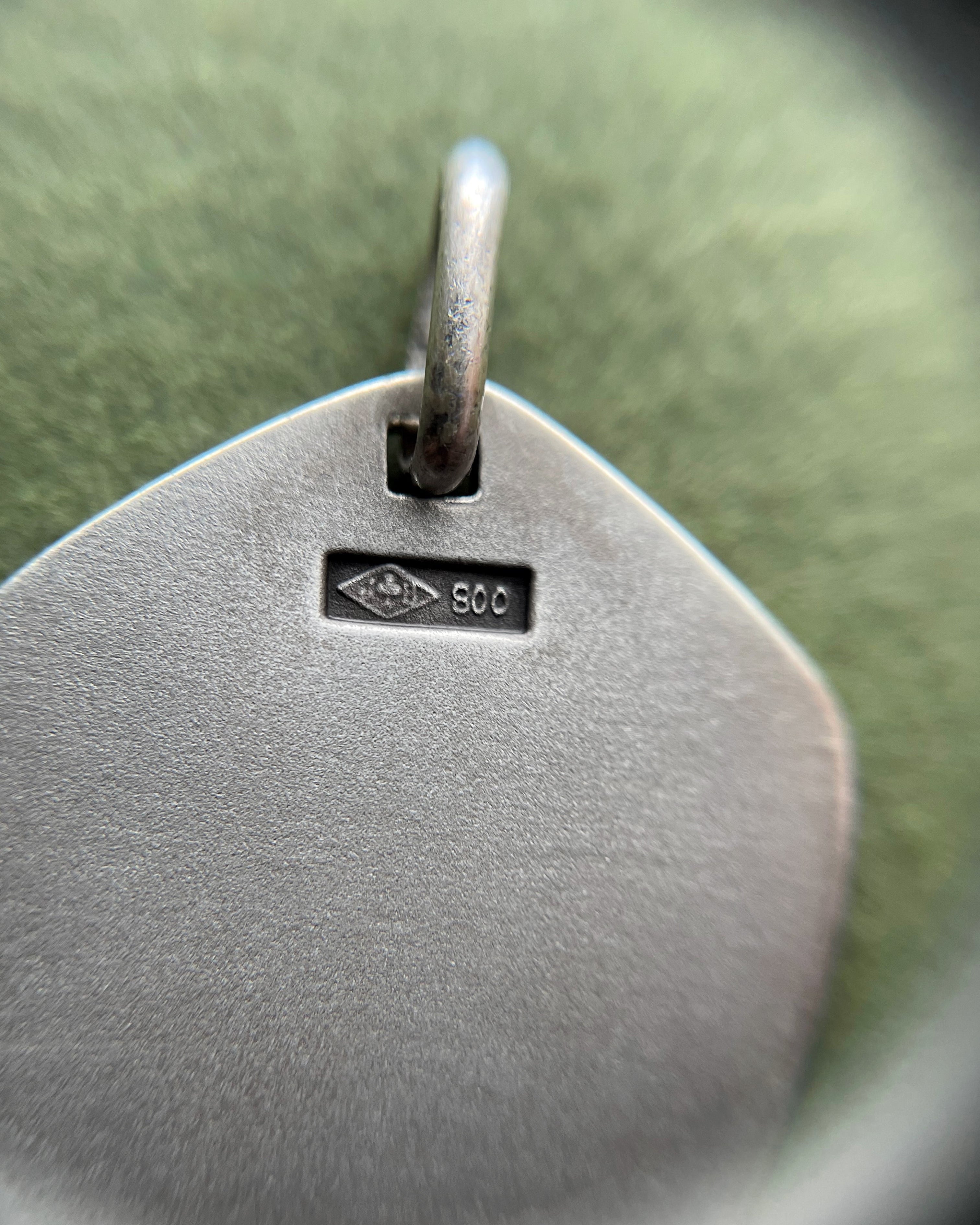 Close-up of 1970s French 800 silver Aquarius zodiac pendant showing hallmark and Jean Balme maker’s mark – Auric Vintage