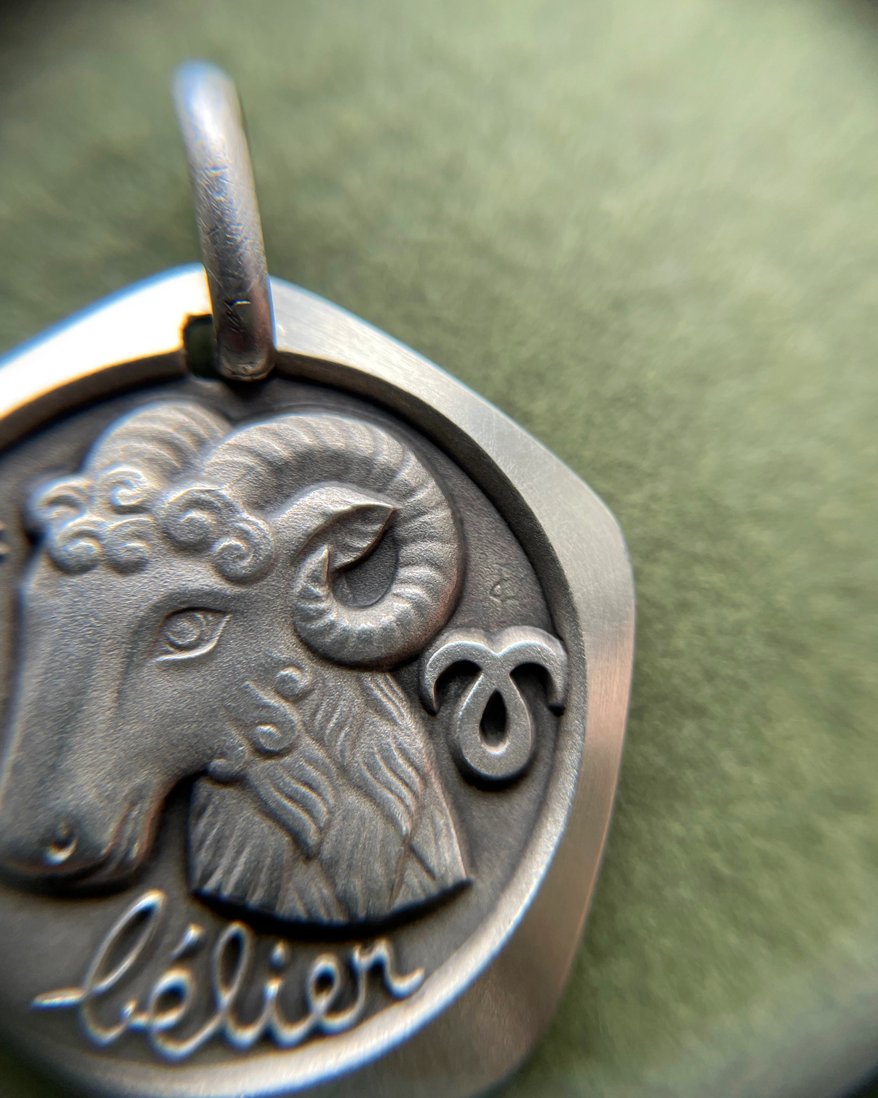Close-up of 1970s French 800 silver Aries zodiac pendant showing ram detail – Auric Vintage