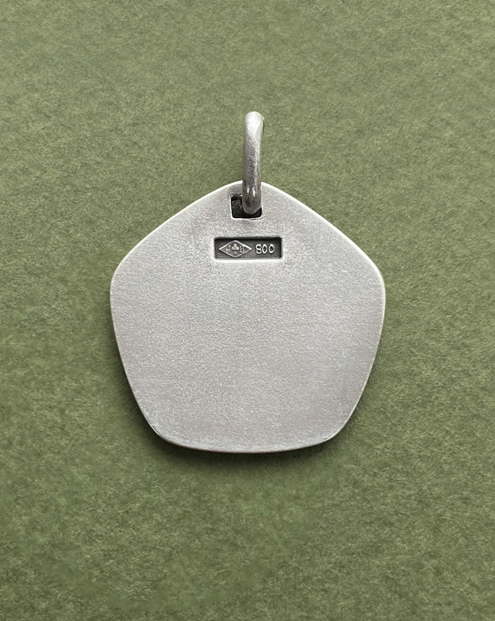 Reverse of 1970s French Aries zodiac pendant in 800 silver showing smooth finish – Auric Vintage