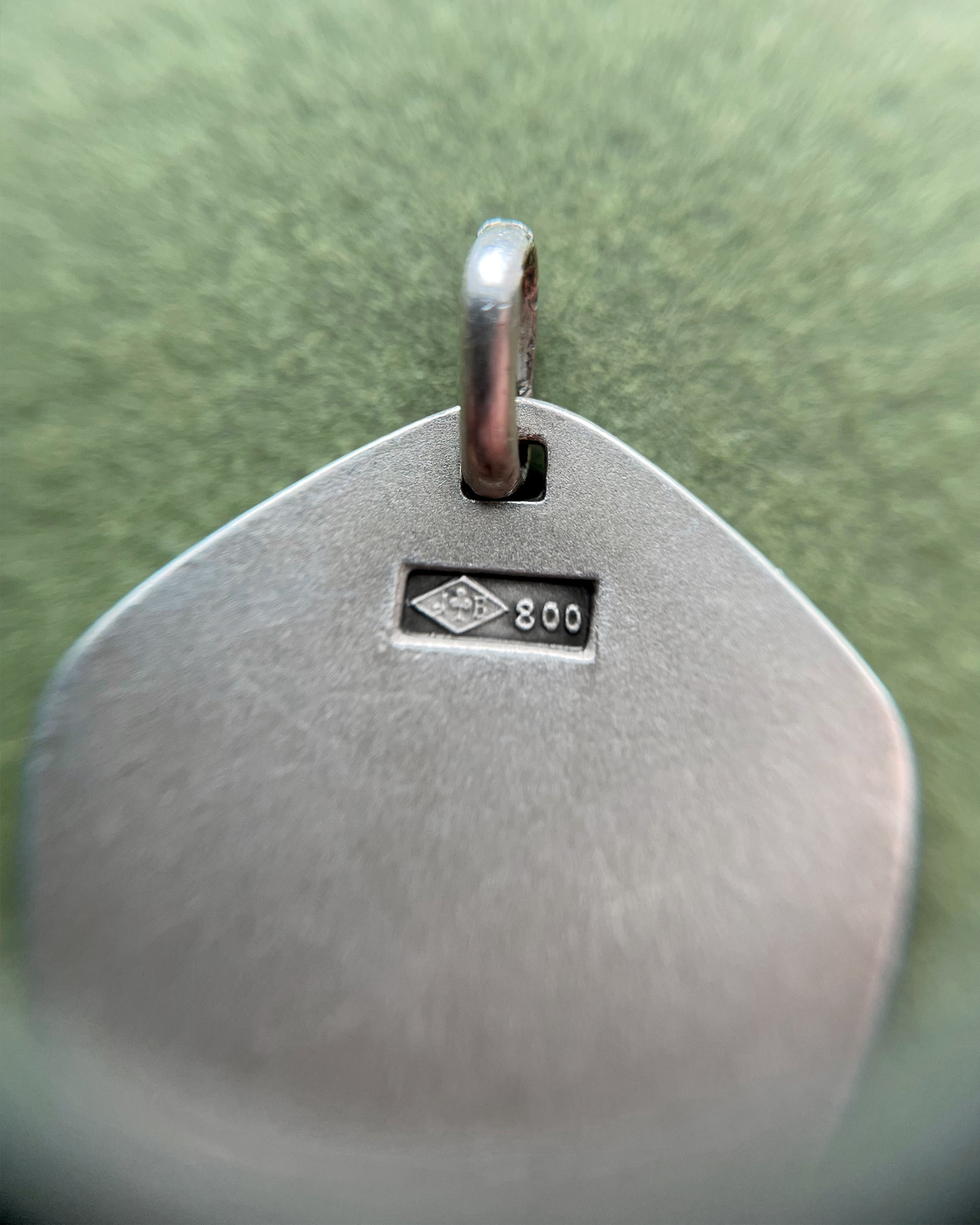 Close-up of 1970s French 800 silver Leo zodiac pendant showing hallmark and Jean Balme maker’s mark – Auric Vintage