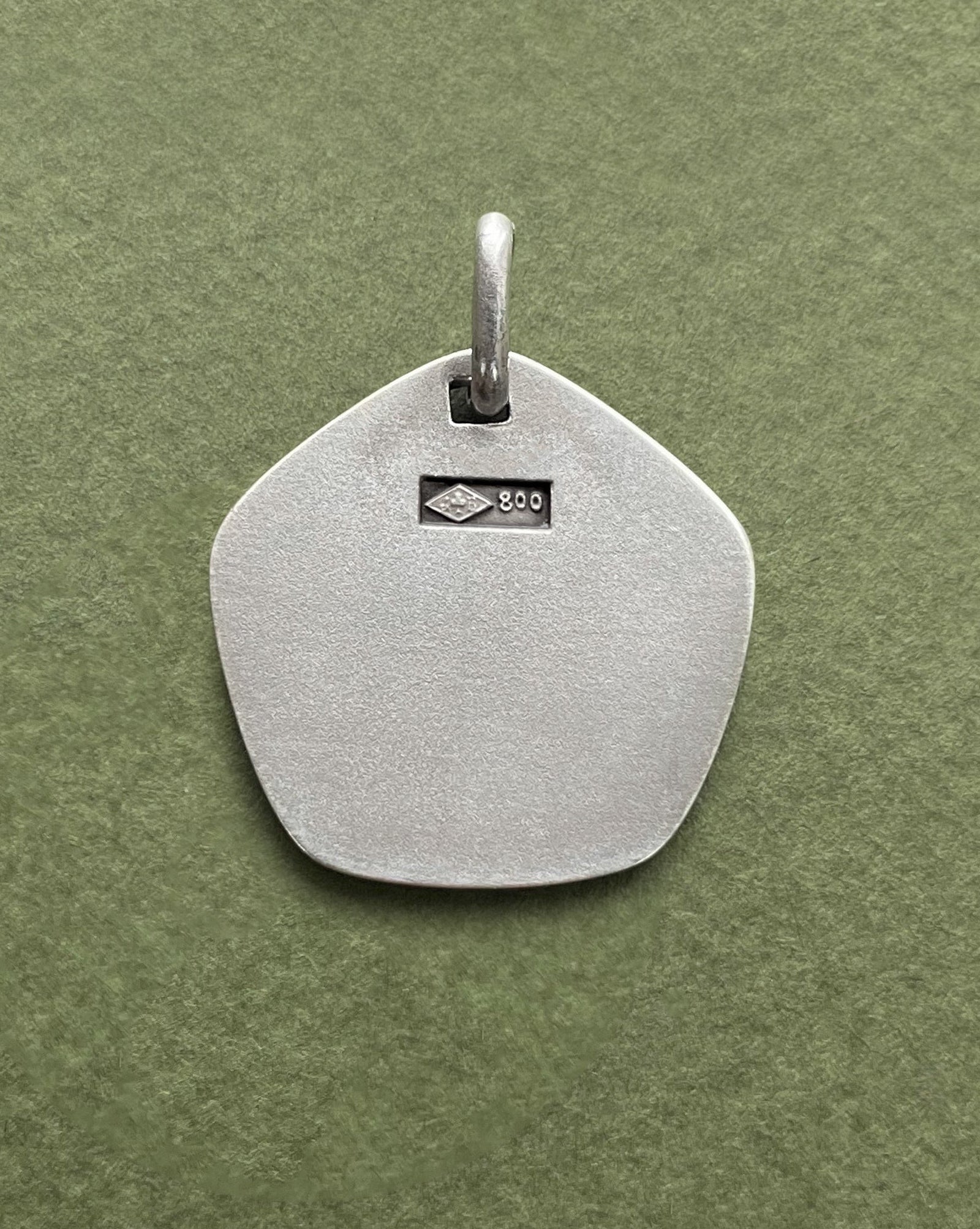 Reverse of 1970s French Leo zodiac pendant in 800 silver showing smooth finish – Auric Vintage
