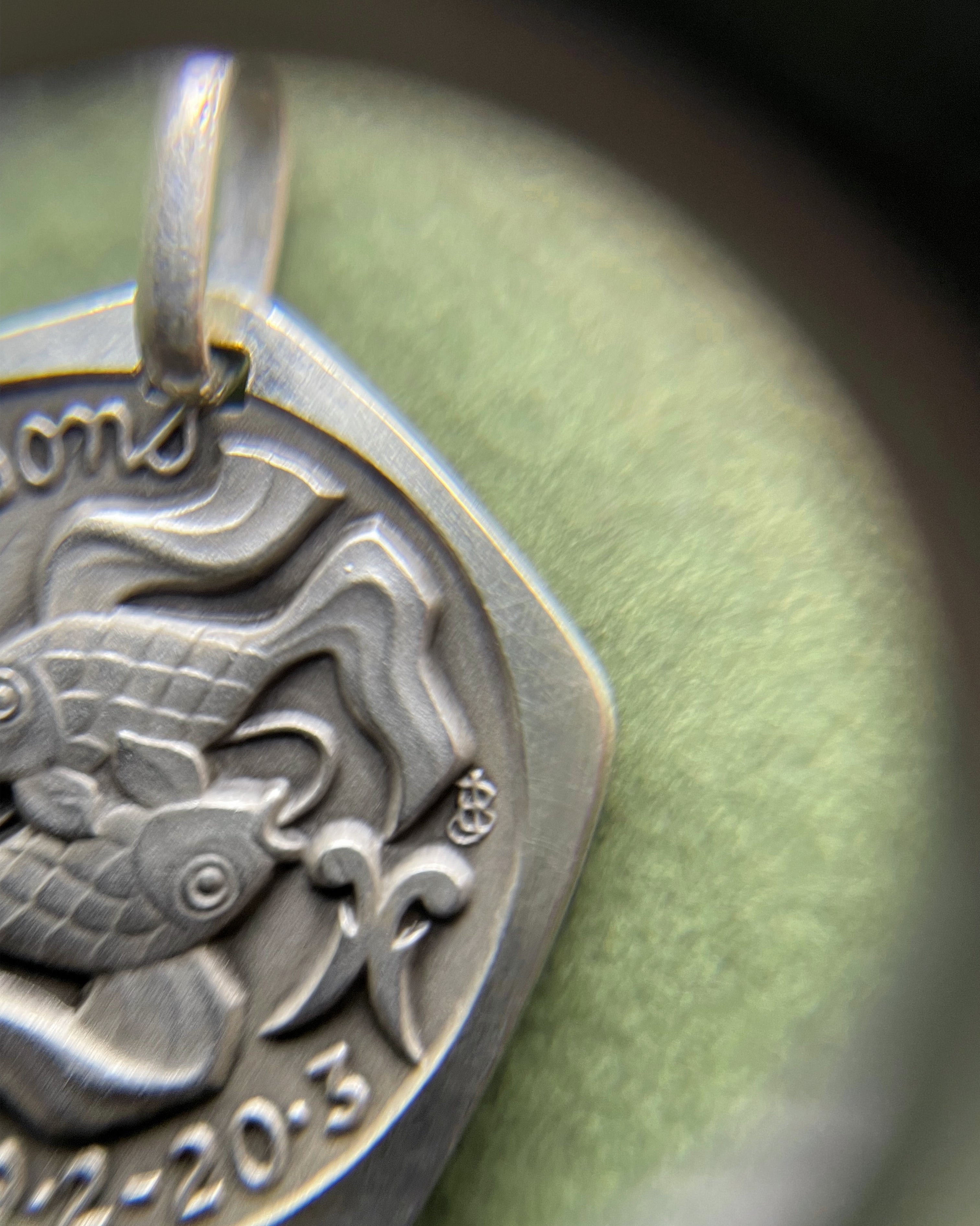 Close-up of 1970s French 800 silver Pisces zodiac pendant showing fish detail – Auric Vintage