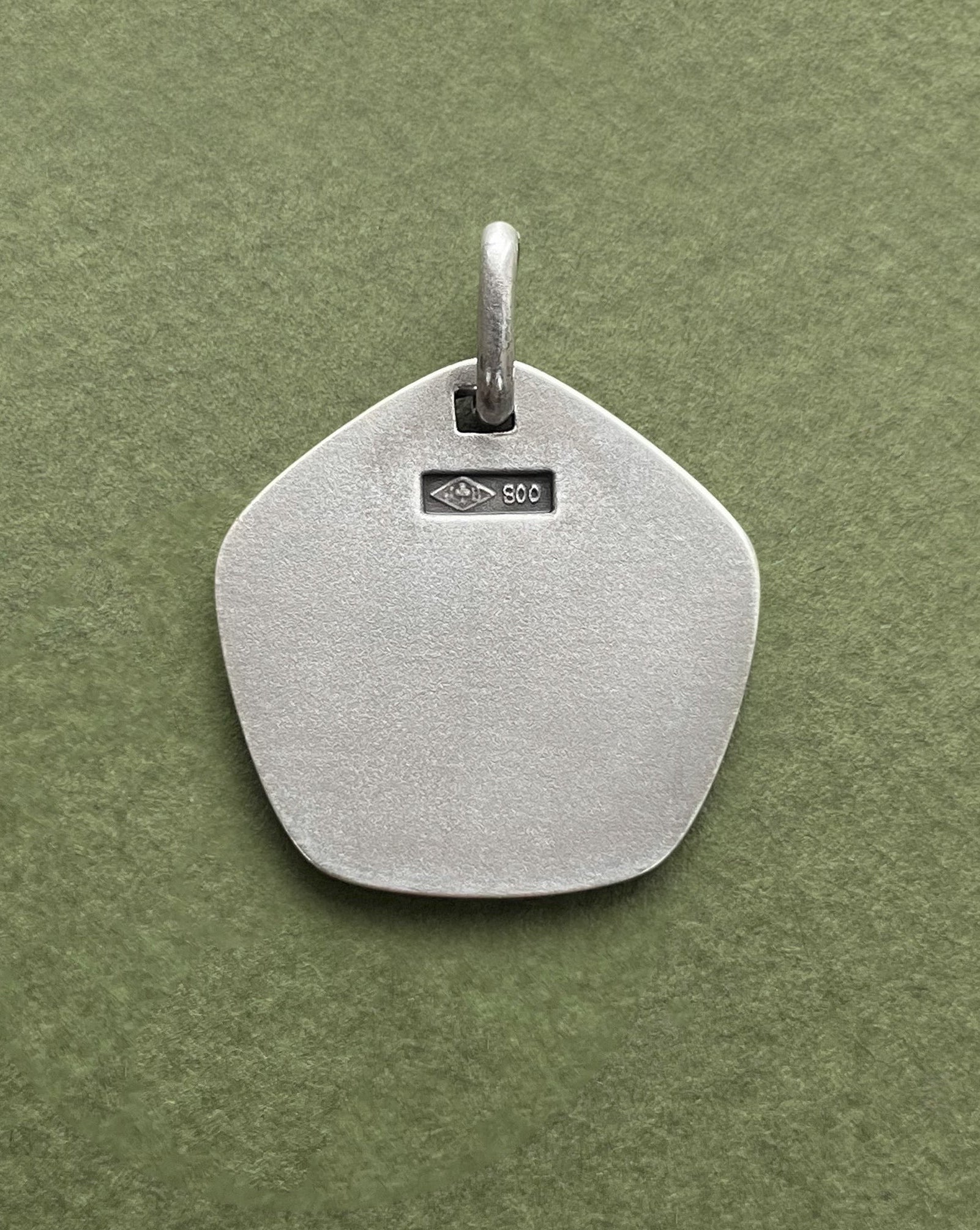 Reverse of 1970s French Sagittarius zodiac pendant in 800 silver showing smooth finish – Auric Vintage