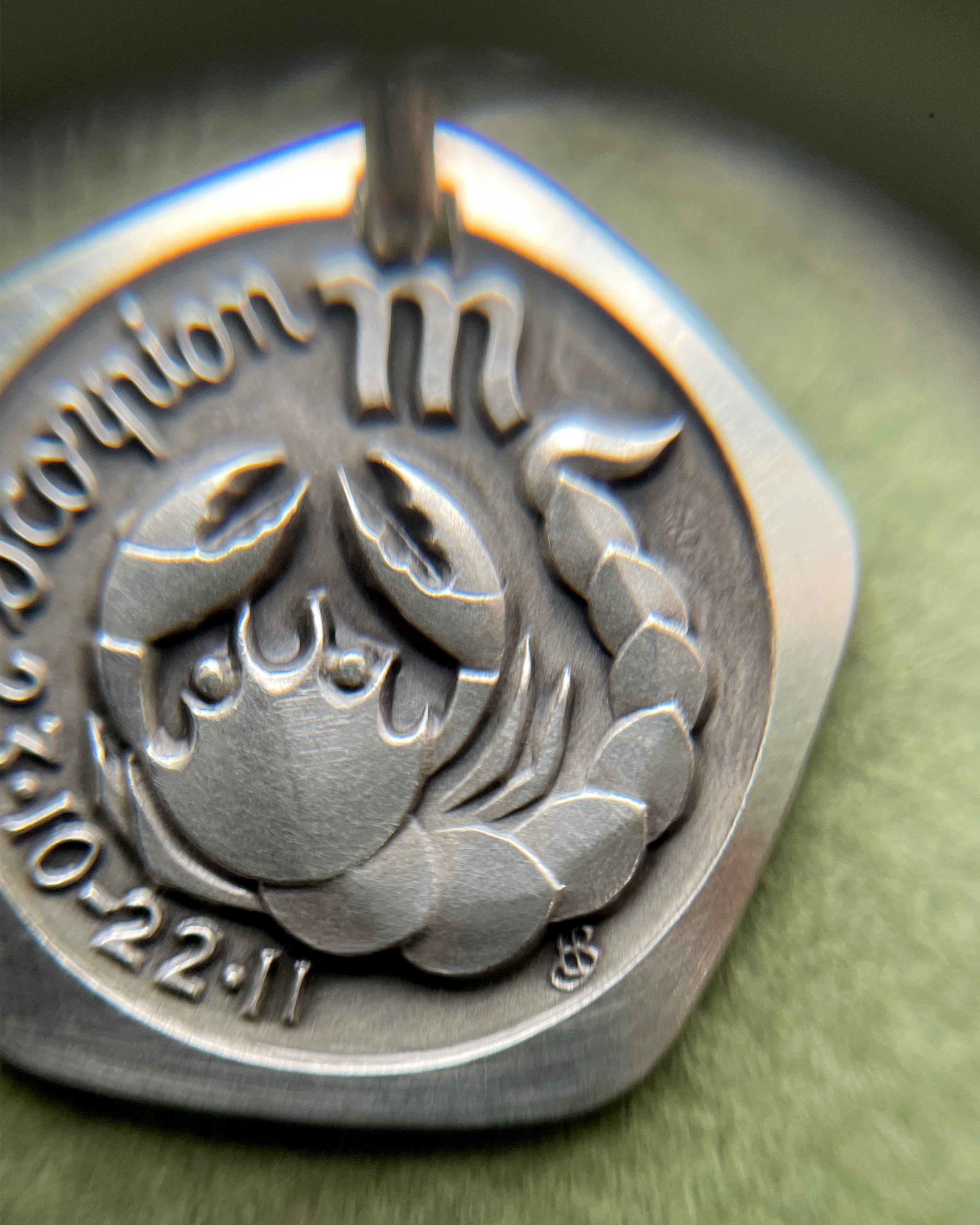 Close-up of 1970s French darkened 800 silver Scorpio zodiac pendant showing scorpion detail – Auric Vintage
