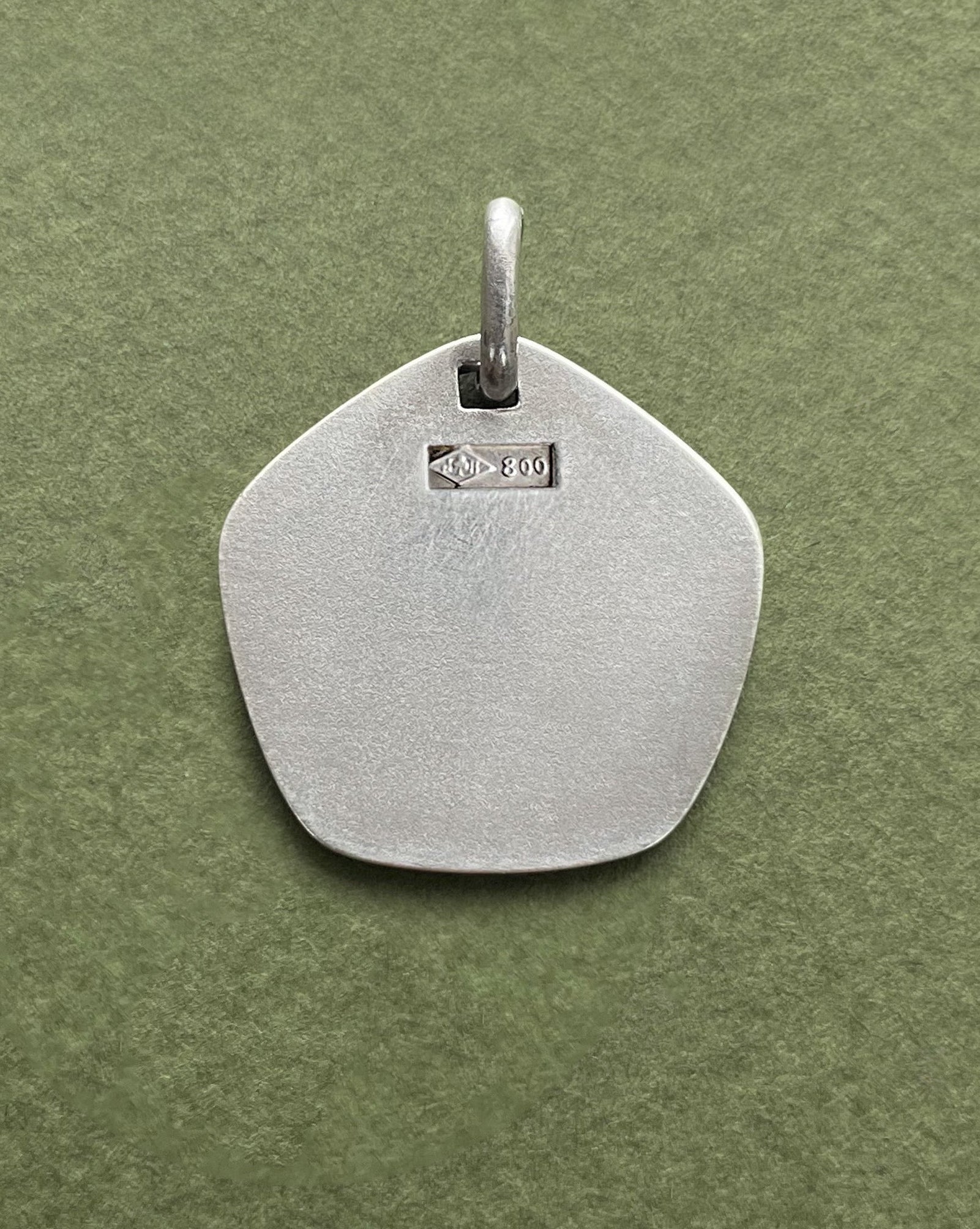 Reverse of 1970s French Taurus zodiac pendant in 800 silver showing smooth finish – Auric Vintage