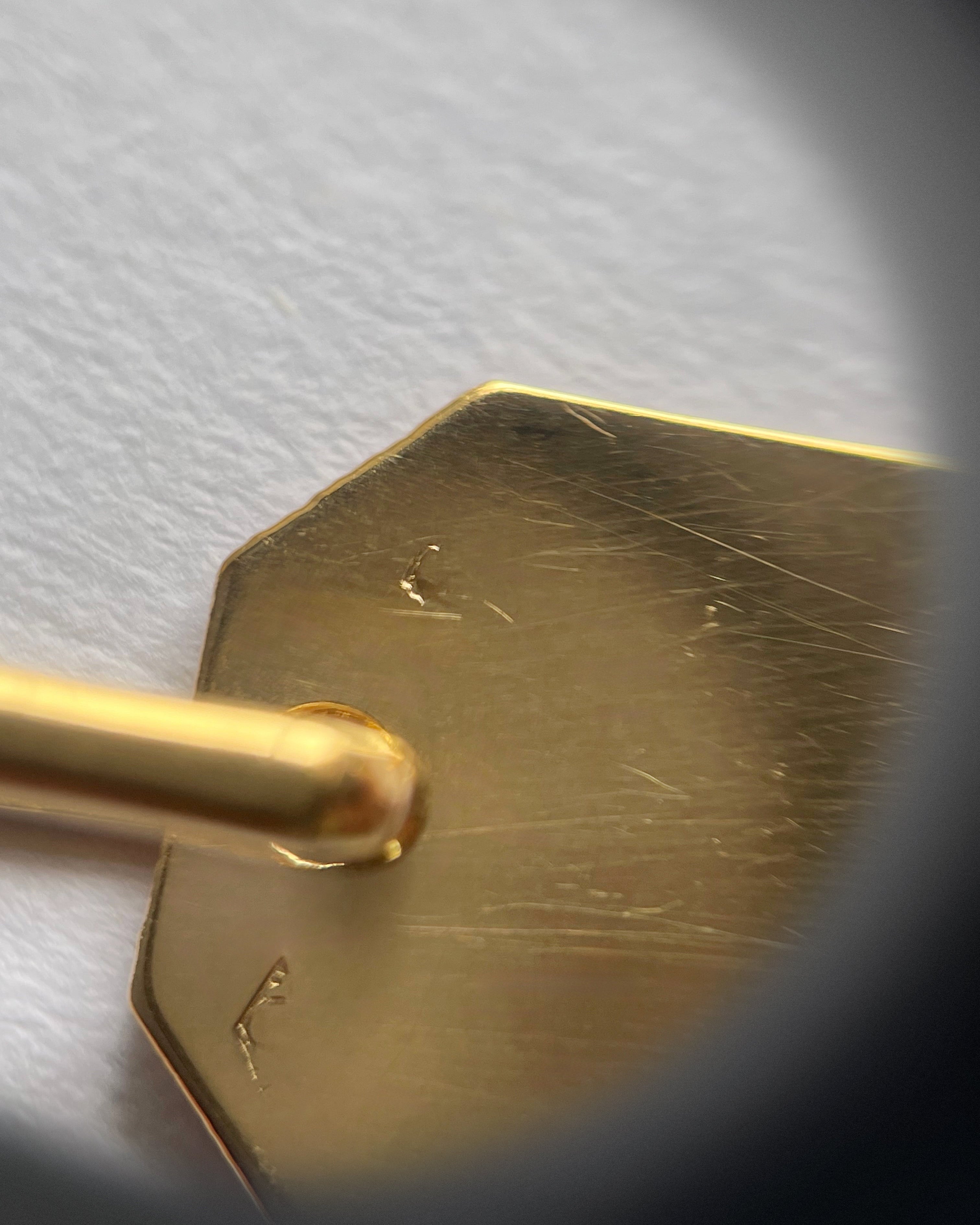 Reverse of 18kt gold St. Christopher pendant showing maker’s mark and French 18kt gold hallmark – Auric Vintage