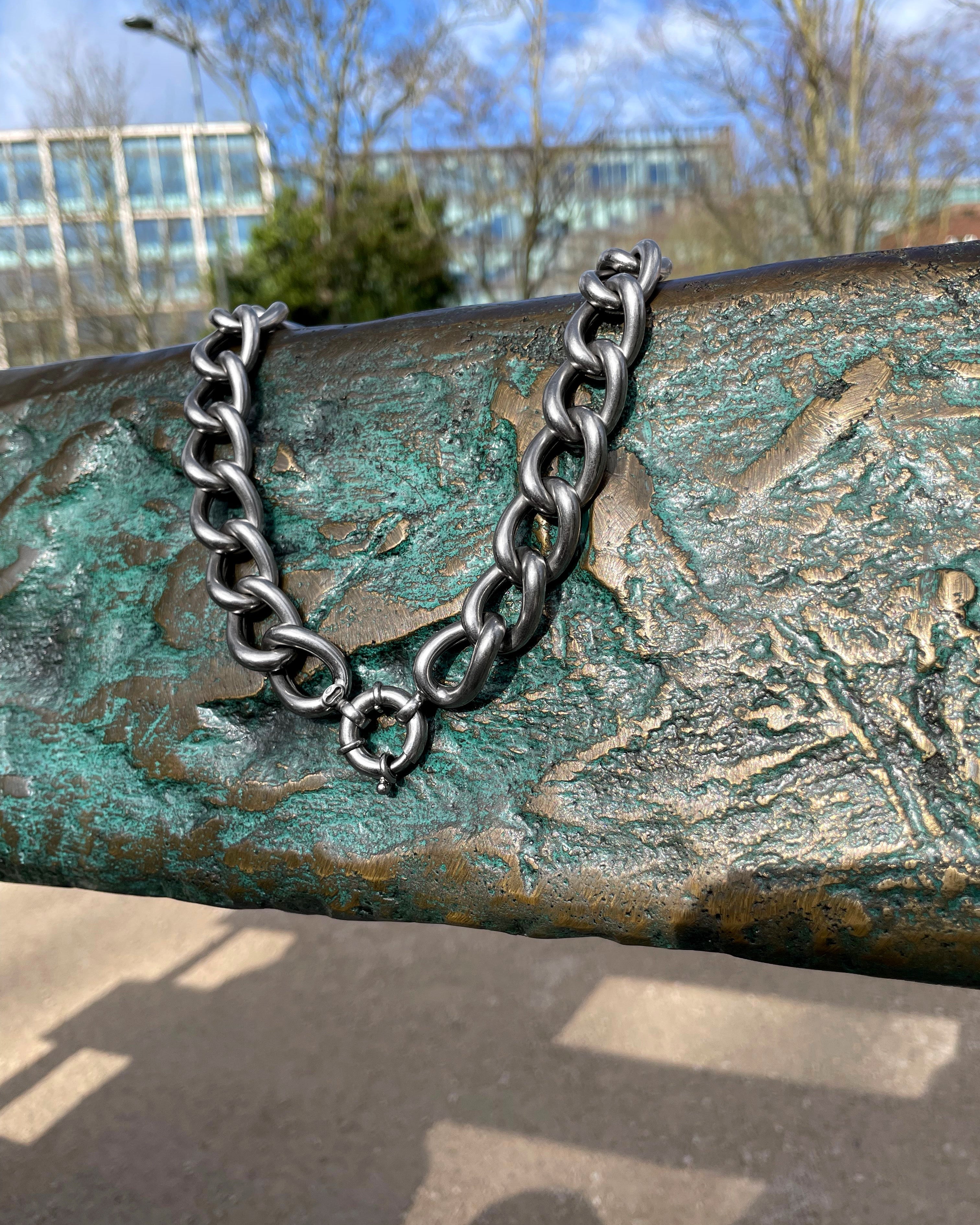 Y2K chunky curb link necklace in sterling silver hanging on chair showing length and drape – Auric Vintage