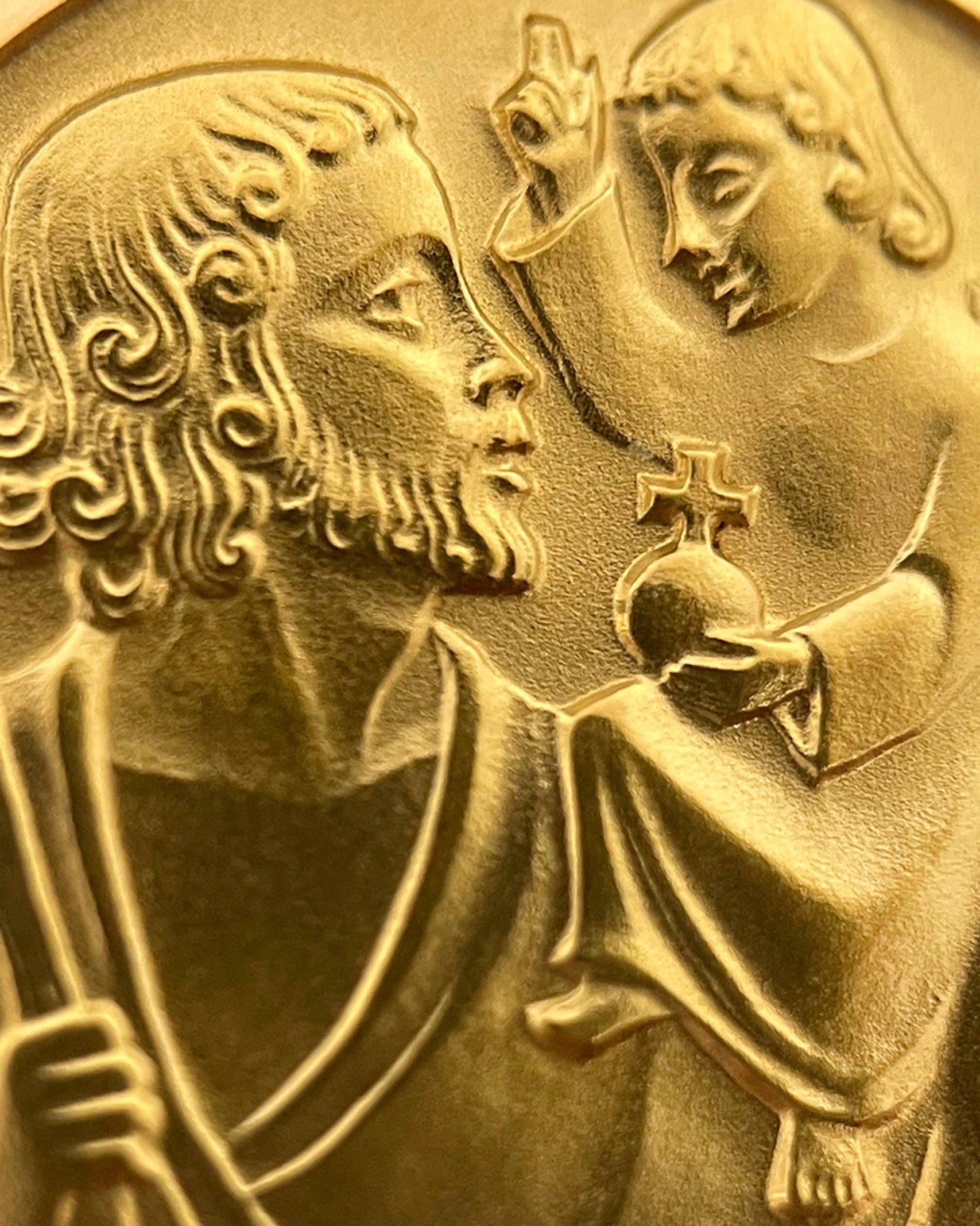 Close-up of vintage French 18kt gold St. Christopher medal showing saint and Christ Child relief – Auric Vintage