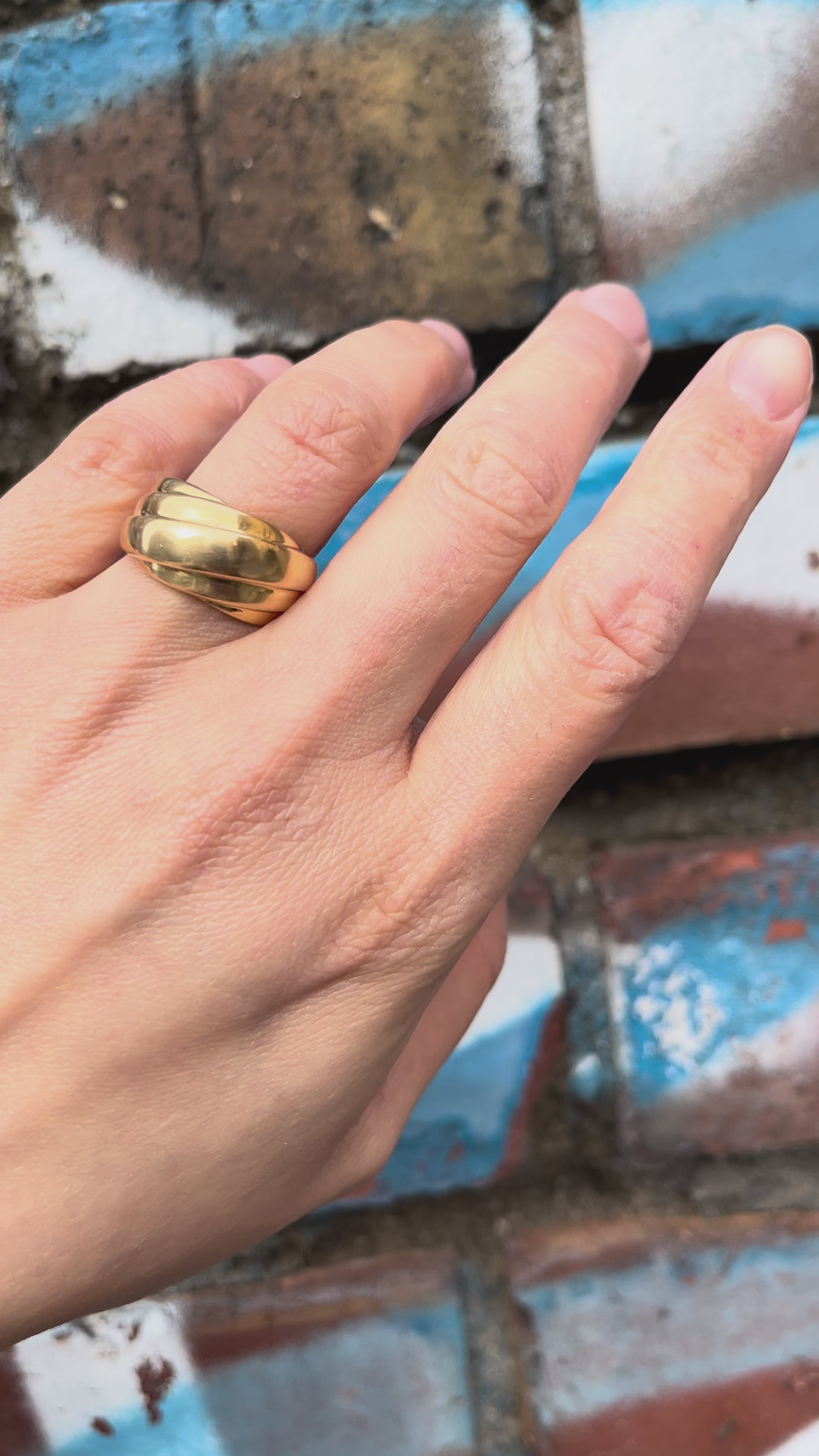 Video of 1980s French 18kt yellow gold draped ring worn on finger showing fluid sculptural form – Auric Vintage