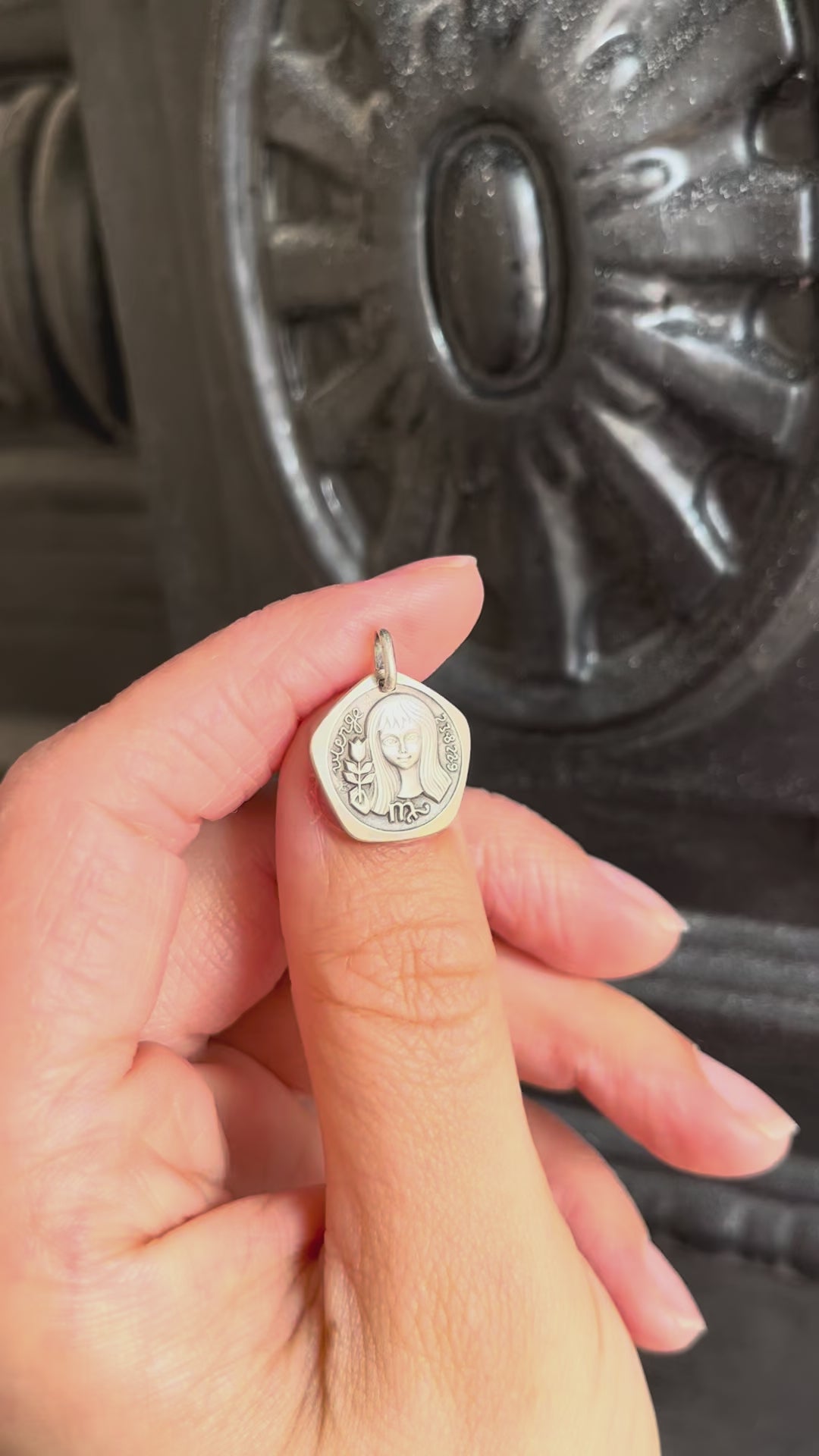 Video of 1970s French Virgo zodiac pendant in 800 silver held in hand showing detail and scale – Auric Vintage