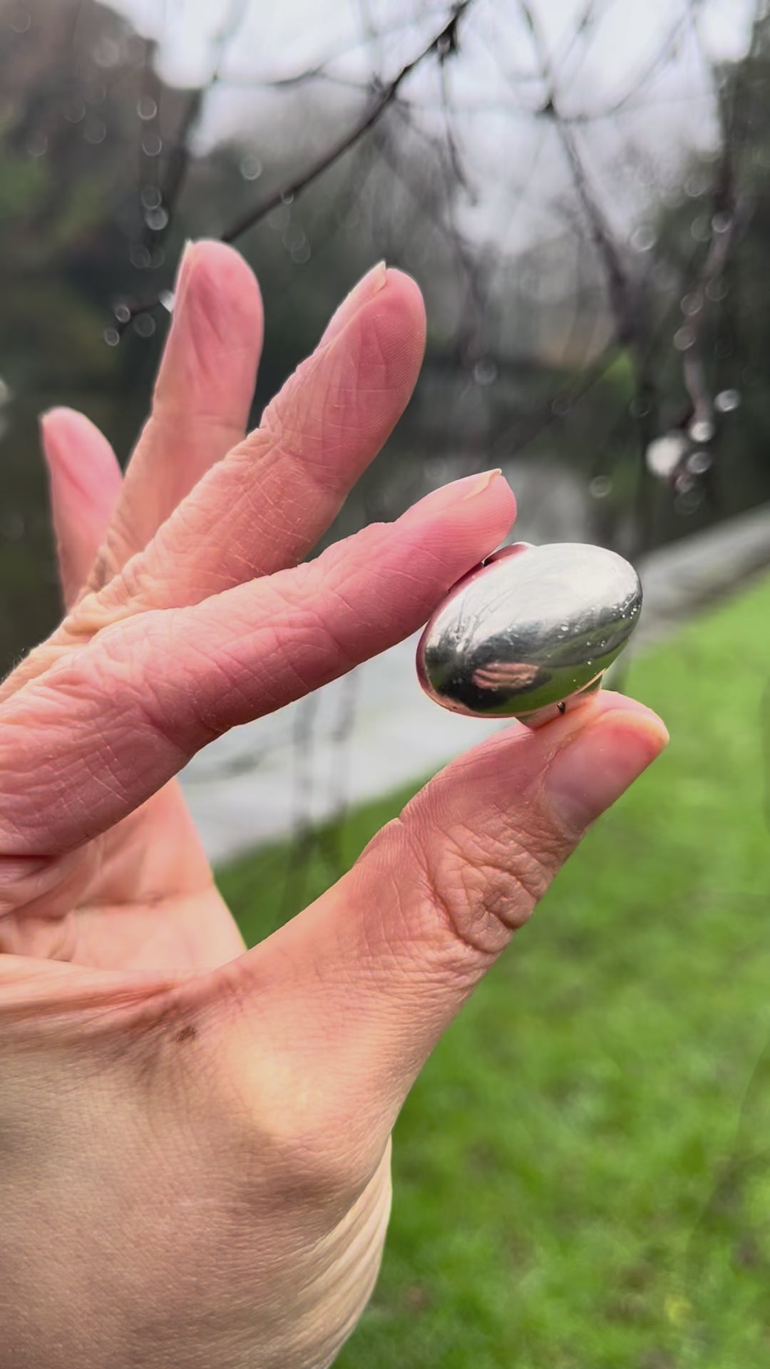 Video of vintage sterling silver moval domed ring held in hand showing sculptural form and polished finish – Auric Vintage