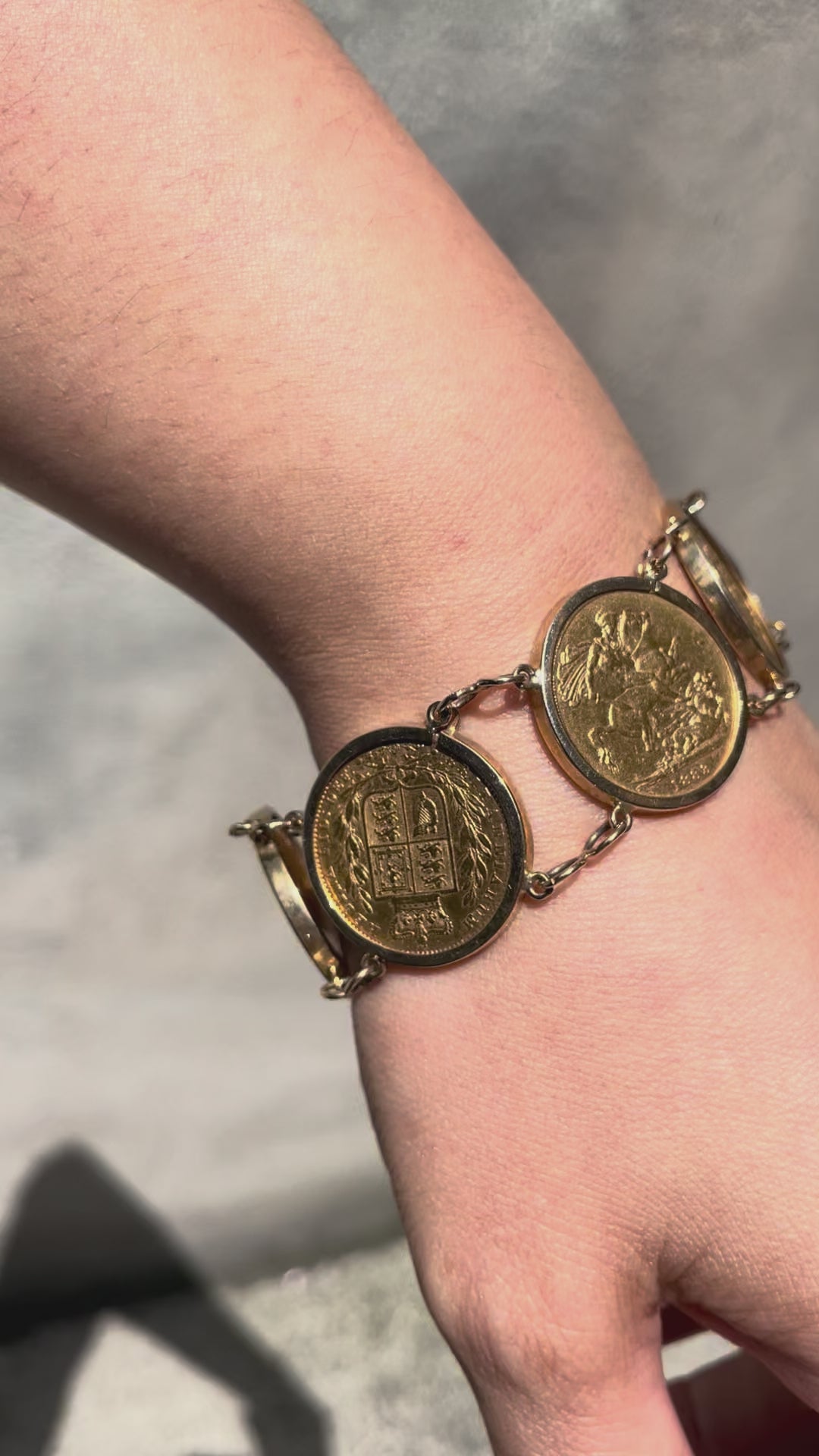 Video of antique six sovereign coin bracelet held in hand showing movement and coin detail – Auric Vintage