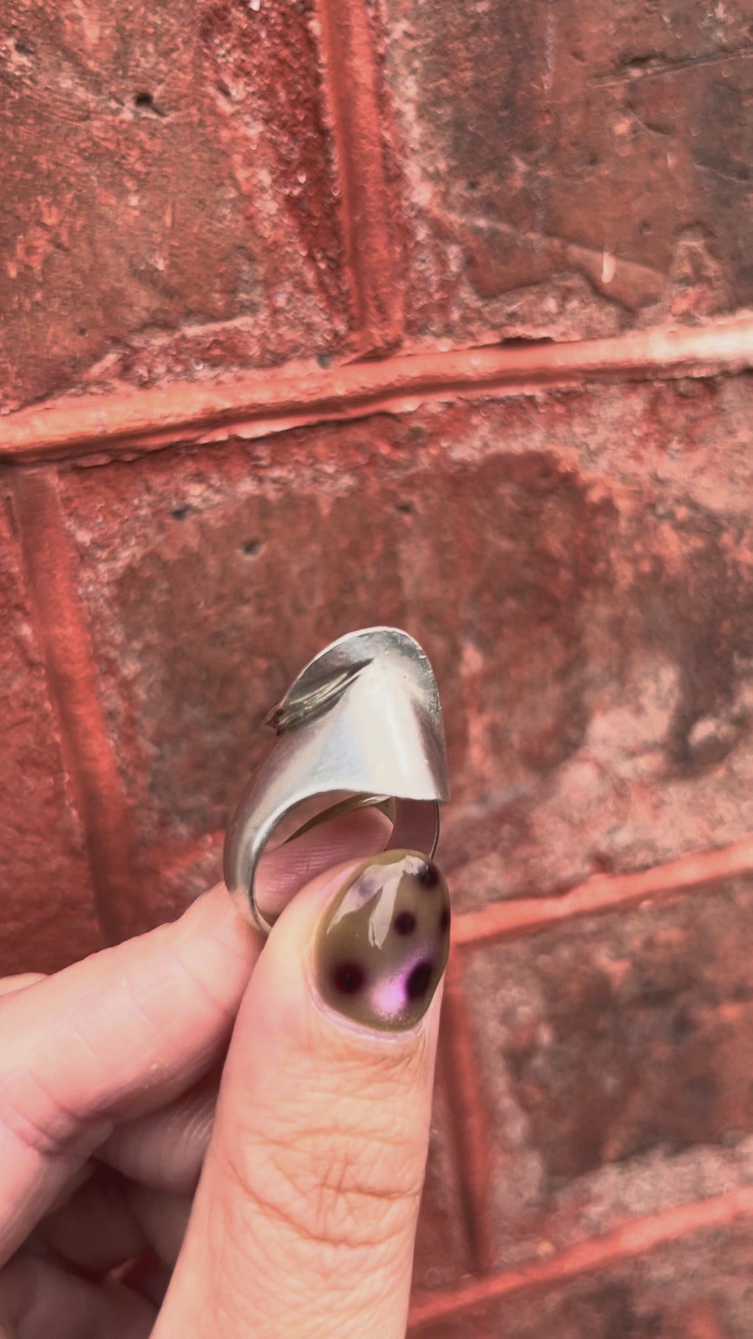 Video of modernist French curvilinear ring in sterling silver held in hand showing sculptural form and polished finish – Auric Vintage