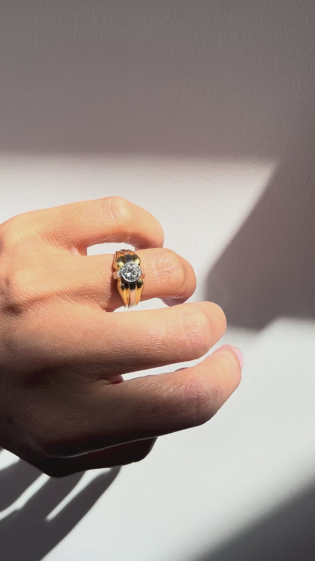 1990s vintage 18kt two-tone gold diamond solitaire engagement ring with a 0.90ct Old European cut diamond and platinum millegrain setting, shown on a hand.