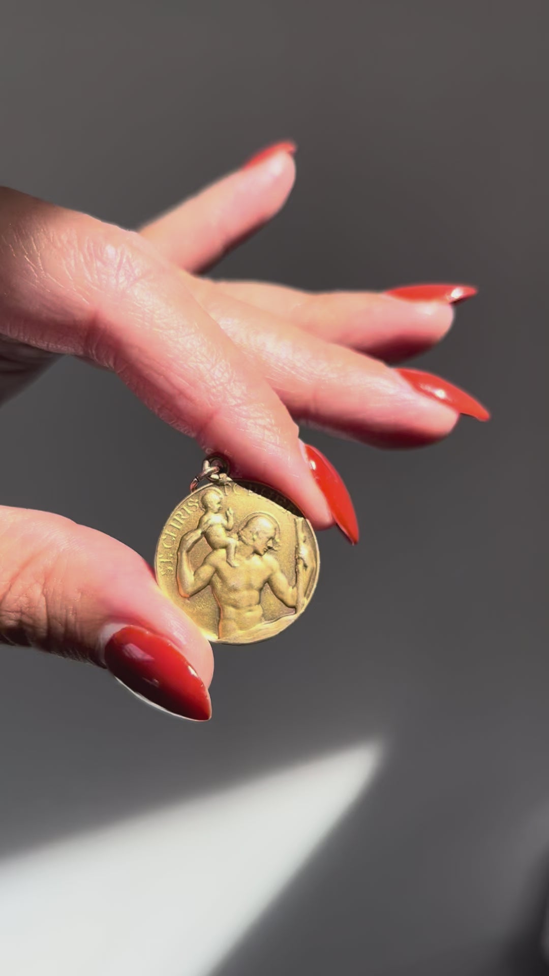 Video of vintage Paul Vincze 9kt gold St. Christopher medal held in hand showing relief and scale – Auric Vintage