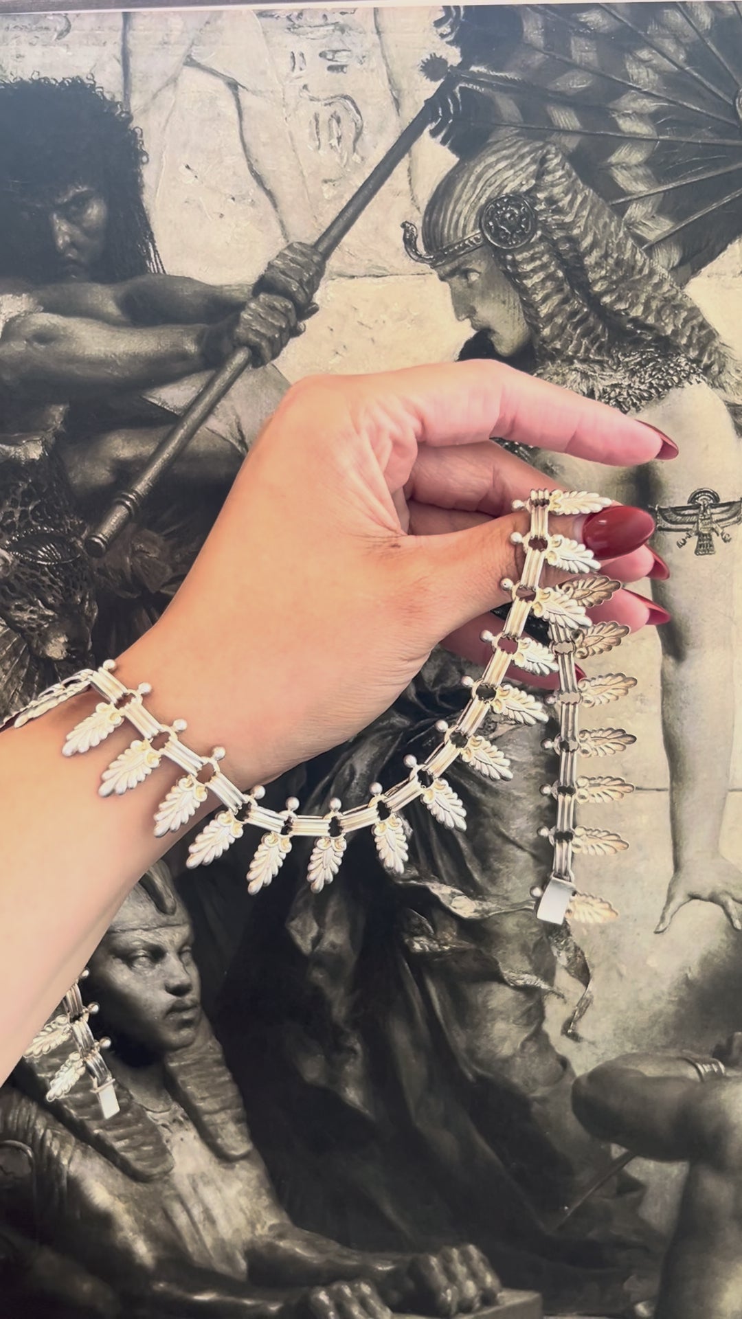 Video of antique Sterling silver Cleopatra palm leaf collar necklace held in hand showing sculptural movement and articulated links – Auric Vintage