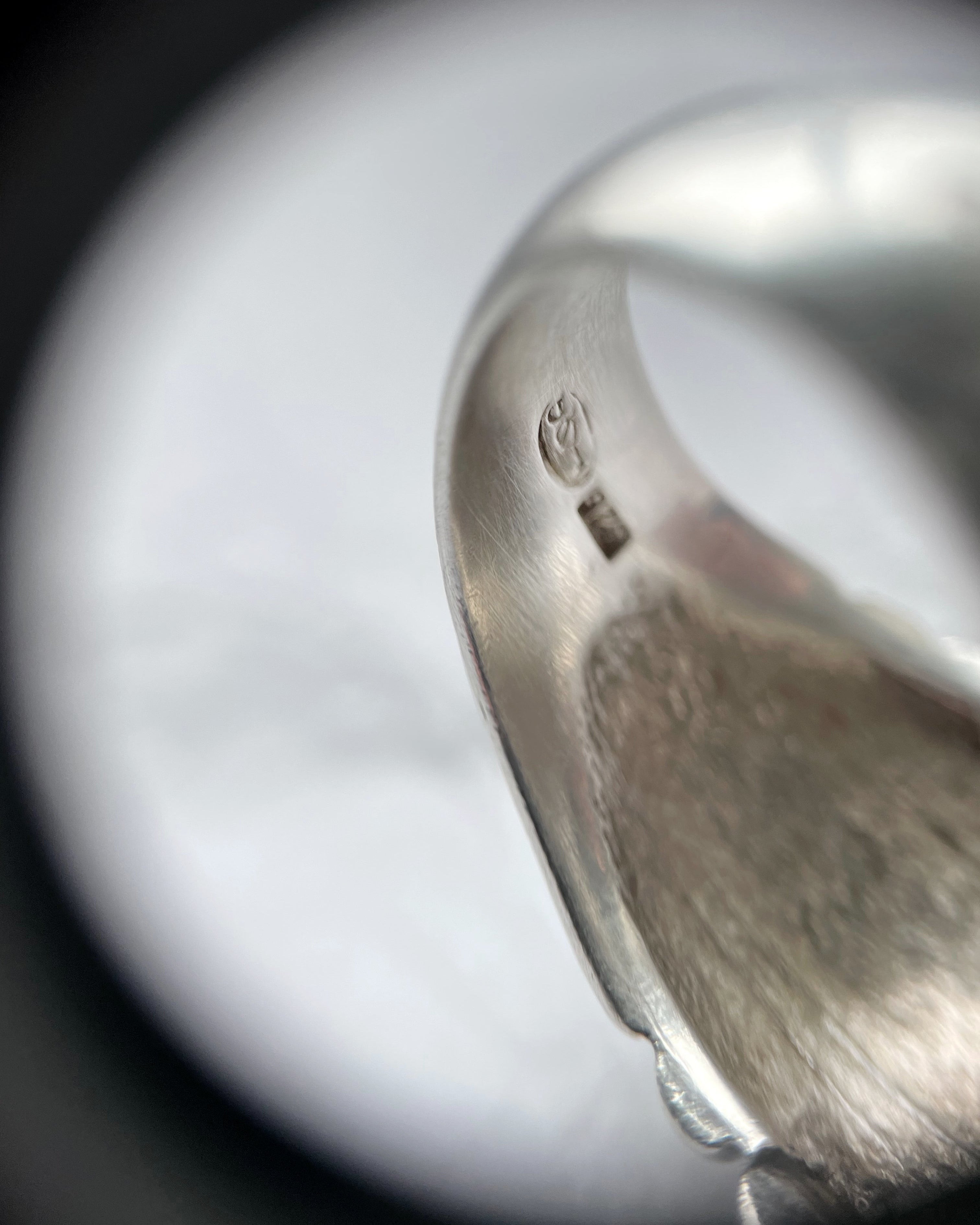 Close-up of retro sterling silver ribbed bombé ring showing hallmark inside shank – Auric Vintage